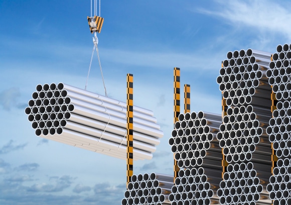 steel beams being carried by crane